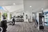Contemporary fitness center with state-of-the-art exercise machines in a bright, spacious setting.