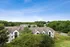 Charming residential complex surrounded by lush greenery and scenic views, offering serene suburban living.