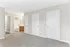 Bright and inviting room with plush carpet, featuring multiple doors and an en-suite bathroom for modern convenience.