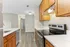 Sleek modern kitchen with elegant wooden cabinetry, marble countertops, and stainless steel appliances, offering a spacious and inviting atmosphere.