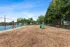 Inviting dog park with agility equipment, vibrant red benches, and lush greenery, perfect for pet-friendly adventures.
