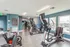Modern fitness center with high-end equipment, natural light, and inspiring decor, perfect for an energetic workout experience.
