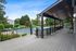 Inviting poolside deck with lush greenery and modern lounge area, perfect for relaxing and entertaining.