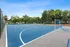 Vibrant outdoor sports court with soccer nets, surrounded by lush greenery and spacious seating areas, perfect for active living.