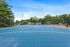 Vibrant outdoor sports court surrounded by lush greenery and modern seating.