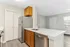 Sleek modern kitchen with stainless steel appliances, elegant wood cabinetry, and a chic marble countertop island.