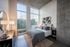 888 at Grand Hope Park Luxurious Bedroom Featuring a Large Window Offering City Views