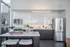 888 at Grand Hope Park Renovated Modern Kitchen with Sleek Cabinetry, Stainless Steel Appliances, and Dining Area