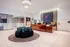 888 at Grand Hope Contemporary Lobby Featuring Seating, Elegant Lighting, and Wood Reception Desk