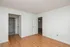 Bright, spacious room featuring polished hardwood floors and a glimpse into a modern bathroom, perfect for effortless living.