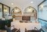 Elegant modern office space with a sleek desk, stylish shelving, and decorative lighting, perfect for productivity and creativity.