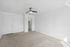 Bright and airy bedroom with plush carpet, modern ceiling fan, and ample natural light.