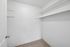 Spacious walk-in closet with built-in shelving, perfect for organized living.