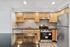 Modern kitchen with sleek stainless steel appliances, granite countertops, and rich wooden cabinetry, perfect for culinary enthusiasts.