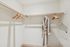Spacious walk-in closet with ample hanging space and elegant robe, perfect for organized living.