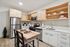 Modern kitchen with stainless steel appliances, sleek cabinetry, and a cozy breakfast bar, perfect for contemporary living.