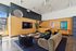 Contemporary lounge with stylish decor, featuring a plush sofa, modern artwork, and abundant natural light.