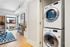 Modern living room with in-unit laundry, bright natural light, stylish decor, and a charming view.