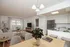 Bright, open-concept living space featuring a stylish kitchen, cozy living room with large window, and elegant dining area.