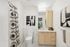 Bright, modern bathroom featuring stylish black and white decor, sleek cabinetry, and a contemporary shower curtain.