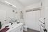 Modern bathroom with elegant fixtures, stylish vanity mirror, and contemporary artwork for a chic, inviting feel.