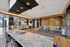 Luxurious open-concept apartment with a modern kitchen, spacious dining area, and stylish lounge overlooking waterfront views.