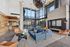 Modern and elegant living space with high ceilings, expansive windows, and chic furniture, creating a bright and welcoming atmosphere.