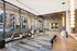 Modern apartment lobby with elegant seating, floor-to-ceiling windows, and stylish lighting, offering a welcoming and luxurious ambiance.