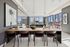 Luxurious open-concept dining and living space with elegant decor and large windows offering stunning city views.