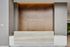 Elegant reception area of The Emerson featuring modern wooden paneling and sleek countertop design.