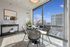 Bright dining area with modern round table, chic decor, and large windows offering stunning city views.