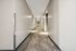 Modern apartment hallway with sleek lighting and plush carpeting for a welcoming atmosphere.
