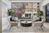 Chic and inviting lobby area with modern cream chairs, stylish round coffee table, and large windows showcasing urban views.