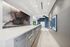 Sleek apartment mailroom with modern art decor, featuring elegant metallic mailboxes and a polished countertop.