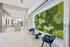 Contemporary lobby area featuring modern seating and a vibrant green living wall art installation.
