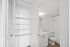Bright and sleek bathroom with built-in shelving and modern fixtures, perfect for stylish living.