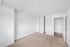 Bright and airy bedroom with plush carpeting, featuring built-in closet space and fresh white walls, ready for personalized design.