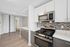 Modern kitchen with sleek stainless steel appliances, elegant tile backsplash, and chic cabinetry, offering a stylish culinary space.