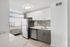 Modern kitchen featuring sleek stainless steel appliances, elegant tile backsplash, and abundant natural light.