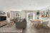 Bright and modern living-dining area with sleek furniture, large windows, and stylish decor, perfect for relaxed living.