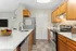 Modern kitchen with sleek countertops, stainless steel appliances, and warm wooden cabinetry, ideal for culinary enthusiasts.