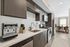 Modern kitchen with sleek dark cabinets, stainless steel appliances, and a cozy dining area with natural light.