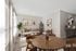 Modern living room with elegant wooden dining set, cozy sofa, and vibrant artwork creating a warm, inviting atmosphere.