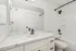 Elegant bathroom featuring a sleek white marble countertop and modern black fixtures, offering a touch of luxury.