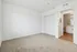 Inviting bedroom interior with plush carpeting, built-in closet, and doorway leading to a modern bathroom.