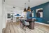 Chic dining area with modern pendant lights and open kitchen featuring sleek cabinetry and stainless steel appliances.