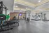 Modern fitness center with state-of-the-art equipment, including treadmills, weight machines, and a sleek design promoting an active lifestyle.