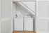 Chic compact laundry space featuring modern washer and dryer under a sloped ceiling.
