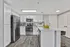 Bright and modern kitchen with sleek stainless steel appliances, elegant white cabinetry, and a spacious island with bar seating.