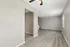 Bright and spacious living area with elegant hardwood flooring and modern ceiling fan, perfect for a cozy home ambiance.